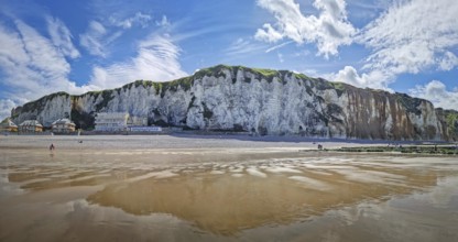 Panoramic view of Dieppe beach in Normandy, France. Majestic white chalk cliffs rise above a pebble