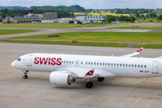 Swiss Airlines Passenger Airplane Taxiing on Runway in a Sunny Summer Day From the Airport in