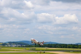 Swiss Airlines Passenger Airplane Take Off From the Runway and Flying Against Blue Sky and Clouds