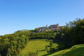 Medieval Old Town with House and Castle Tower on a Hill with Forest in a Sunny Summer Day with Blue