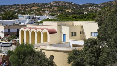 Primary school, Panorama of a Mediterranean building with arches and hills in the background,