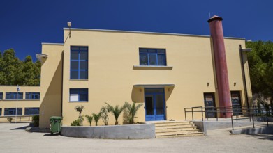 Gymnasium, Modern beige building with blue doors and windows under a clear sky, Historicism, Art
