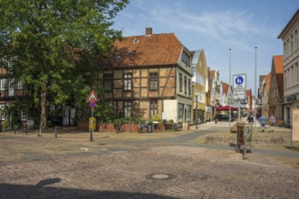 Historic half-timbered houses with red bricks, quiet street neighbourhood with bicycles, Verden an