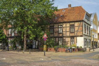 Half-timbered building with red bricks on a quiet street. Bicycles are also available, Verden an