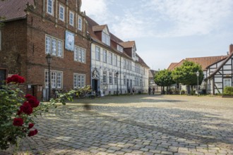 Historic half-timbered houses with cobbled square and roses. Quiet and peaceful atmosphere, Verden