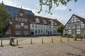 Historic half-timbered houses on a sunny day. Quiet neighbourhood, paved square, Verden an der