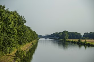 Canal with bridge and green banks, peaceful and quiet surroundings, Weser cycle path, district of