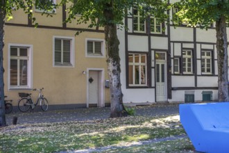 Quiet street scene with half-timbered houses, a bicycle and a summery atmosphere, Marienkirchplatz,