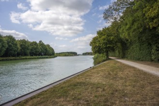 Idyllic river with adjoining path, framed by trees under a partly cloudy sky, Senden, Münsterland,
