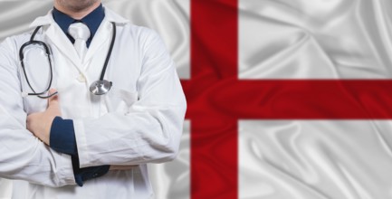 Male doctor with stethoscope on England flag. Doctor holding stethoscope on England flag