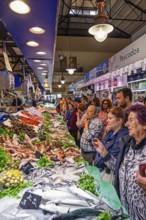 People shopping at a fish stall in fish market at a market hall, Palma de Mallorca, Mallorca, Spain