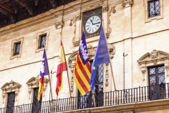 Spanish and Mallorcan flags with the EU flag on the balcony at city hall in Palma, Palma de
