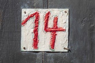 House number sign number fourteen on a half-timbered house in the old town centre, Hameln, Lower