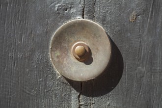 Old bell on a half-timbered house in the old town centre, Hamelin, Lower Saxony, Germany