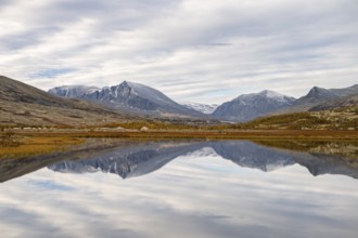 Reflection of the autumn landscape in Rondane National Park, Berge, Døråldalen, Norway