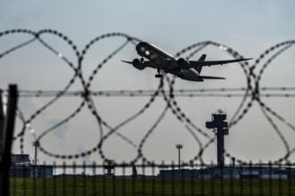 Symbolic image security at the airport, outer fence at Düsseldorf International Airport, steel wire