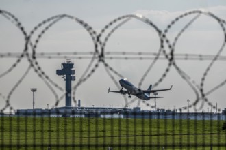 Symbolic image security at the airport, outer fence at Düsseldorf International Airport, steel wire
