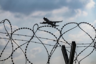 Symbolic image security at the airport, outer fence at Düsseldorf International Airport, steel wire