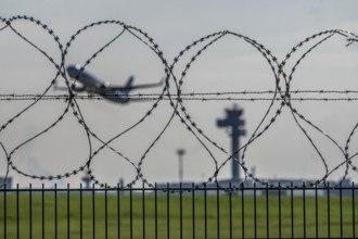 Symbolic image security at the airport, outer fence at Düsseldorf International Airport, steel wire