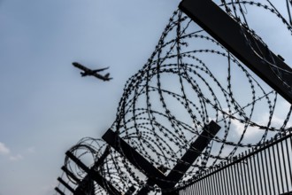 Symbolic image security at the airport, outer fence at Düsseldorf International Airport, steel wire