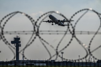 Symbolic image security at the airport, outer fence at Düsseldorf International Airport, steel wire