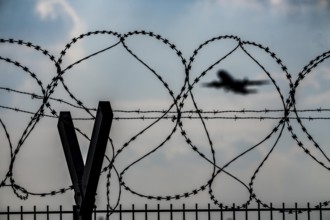 Symbolic image security at the airport, outer fence at Düsseldorf International Airport, steel wire