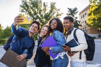 Group of smiling multi ethnic students standing outdoors on campus, celebrating friendship, youth,