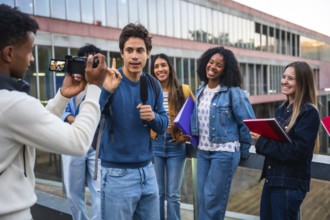 Group of diverse university students filming an interview on campus, one student speaking into a