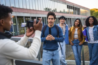 Group of diverse university students collaborating, with one student holding a microphone and
