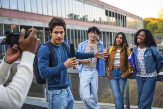 Young diverse students collaborating on a media project, a man holding a boom microphone