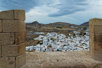 View from the Acropolis of Lindos to the city with white houses and cloudy sky, Acropolis, Lindos,
