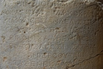 Ancient Greek inscription carved in stone, with clear texture and traces of age, Acropolis, Lindos,