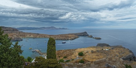 View of the coastal landscape of Lindos with the harbour full of boats, Acropolis, Lindos, Rhodes,