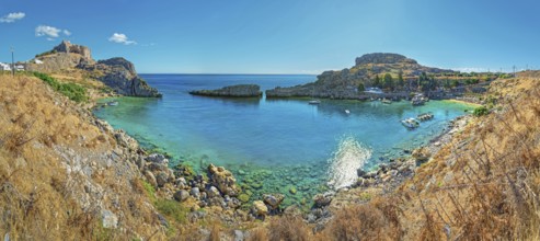 Clear panoramic view of Paulus Bay of Lindos with turquoise water and boats, Acropolis, Lindos,