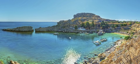 Panoramic view of the calm Paulus Bay of Lindos with turquoise-coloured water, surrounded by