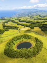 Pond Pau Pique and Lush Green Hills with Pasturelands. Atlantic Ocean. Azores, Sao Miguel Island.