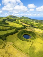 Pond Pau Pique and Lush Green Hills with Pastureland and Trees. Shadows of Clouds. Atlantic Ocean.