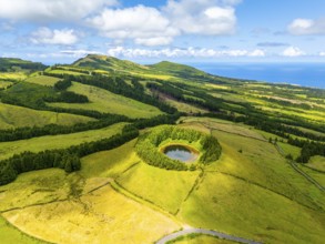 Pond Pau Pique and Lush Green Hills with Pastureland and Trees. Shadows of Clouds. Atlantic Ocean.