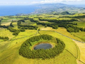 Lake Pau Pique and Lush Green Hills with Pasturelands on Sunny Day. Atlantic Ocean. Azores, Sao