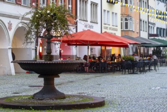 Fountain, outdoor seating of a restaurant, sunshades, market square, Feldkirch, Vorarlberg, Austria