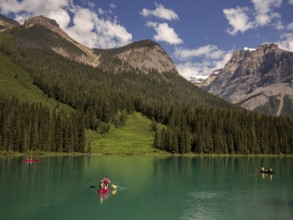A group canoeing on Emerald Lake with the dramatic Canadian Rocky Mountains as a scenic backdrop