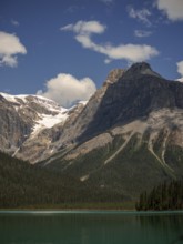 Towers of snowy peaks of the Canadian Rocky Mountains next to Emerald Lake inside Yoho National