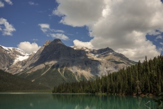 Majestic mountain range of the Canadian Rocky Mountains and Emerald Lake under a clear sky inside