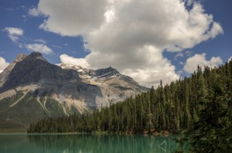 The Canadian Rocky Mountains with clouds above Emerald and dense forest inside Yoho National Park,
