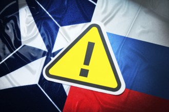 The flags of NATO and Russia with danger sign