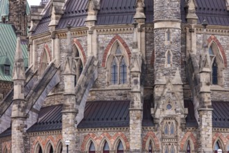 A close-up of the Canadian Parliament Buildings with stone facade with gothic architectural details