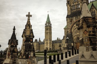 View of the Canadian parliament building from the foreground of stone monuments, featuring gothic