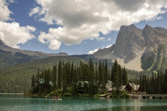 Peaceful Emerald Lake with cabins of Emerald Lake Lodge and forested Canadian Rocky Mountains under