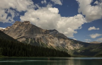 Majestic Canadian Rocky Mountains and tranquil Emerald Lake with a dramatic sky filled with clouds