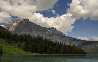 The Canadian Rocky Mountains and forests framing Emerald Lake with a sky full of clouds inside Yoho